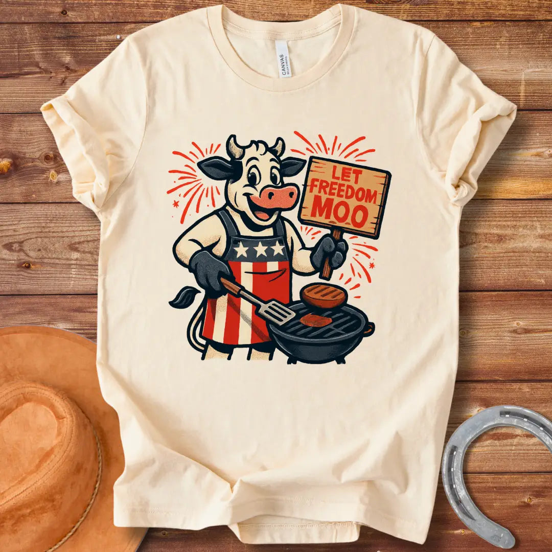 Illustration of a patriotic cow grilling burgers with a "Let Freedom Moo" sign, celebrating American Independence
