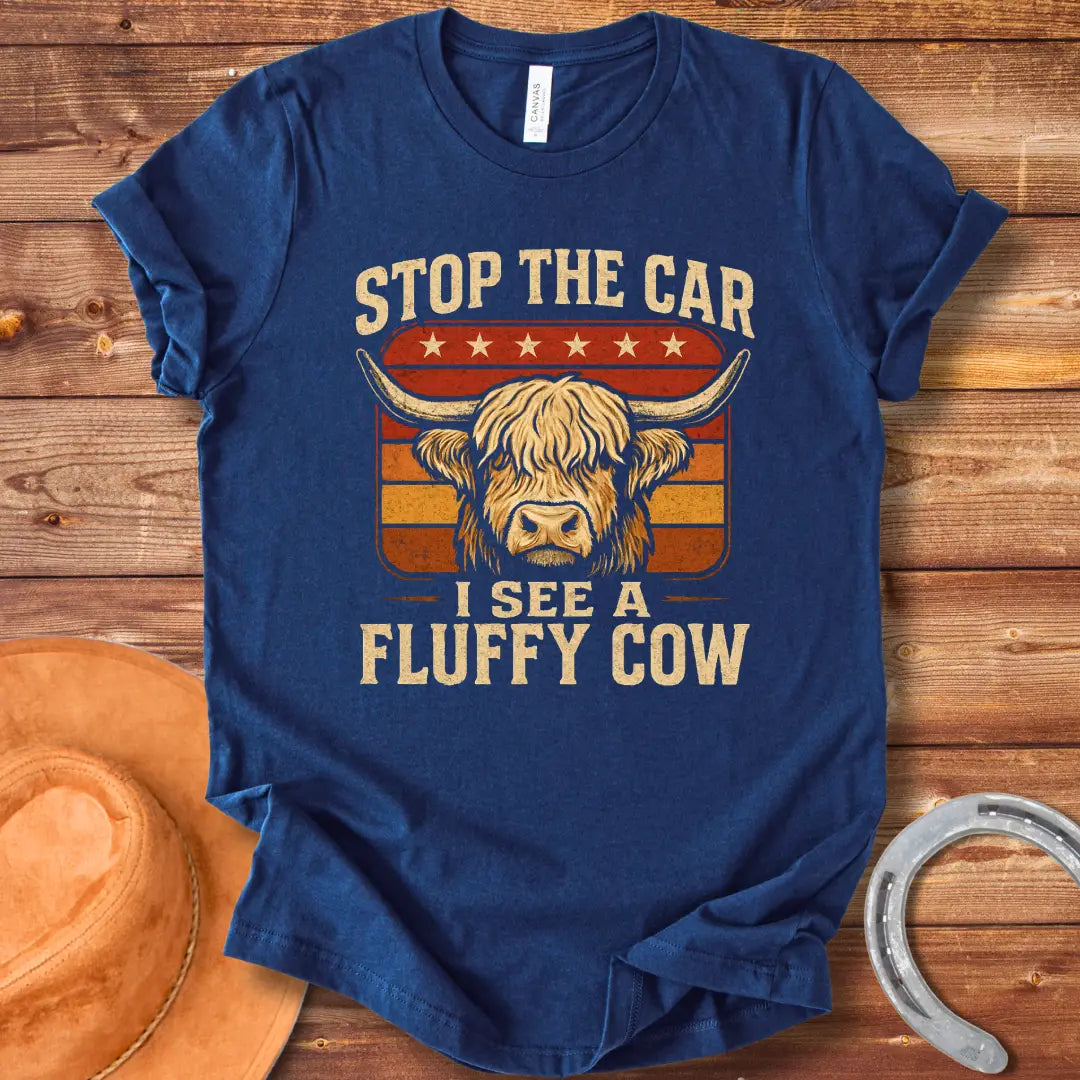Vintage t-shirt featuring a Highland cow with the text 'Stop the Car, I see a fluffy cow' in a retro style.