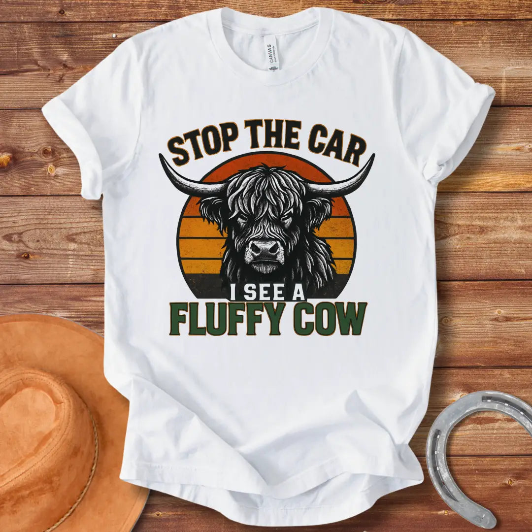 Vintage t-shirt featuring a Highland cow with the text 'Stop the Car, I see a fluffy cow' in a retro style.