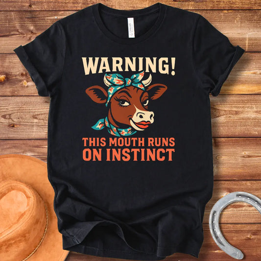Illustration of a cow with a bandana and the words 'Warning! This Mouth Runs On Instinct' on a black background.