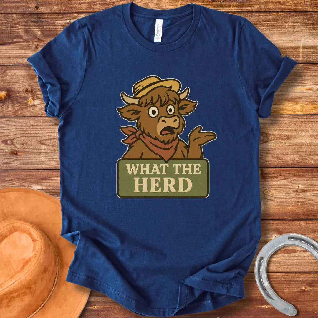 Funny t-shirt design featuring a surprised cow with the words 'What The Herd?' on a sign.