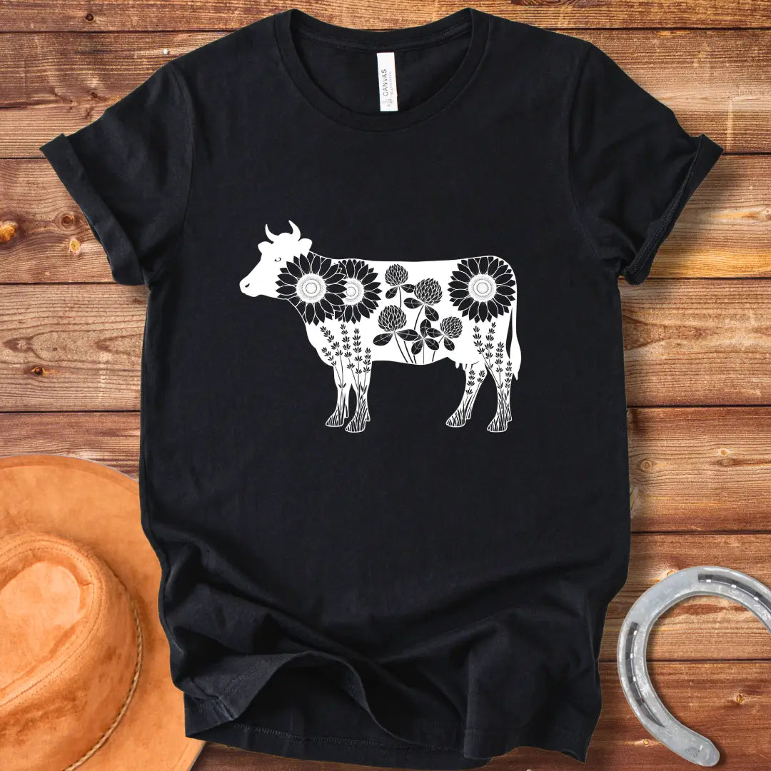 Black and white illustration of a cow filled with sunflowers, clover and lavender flowers