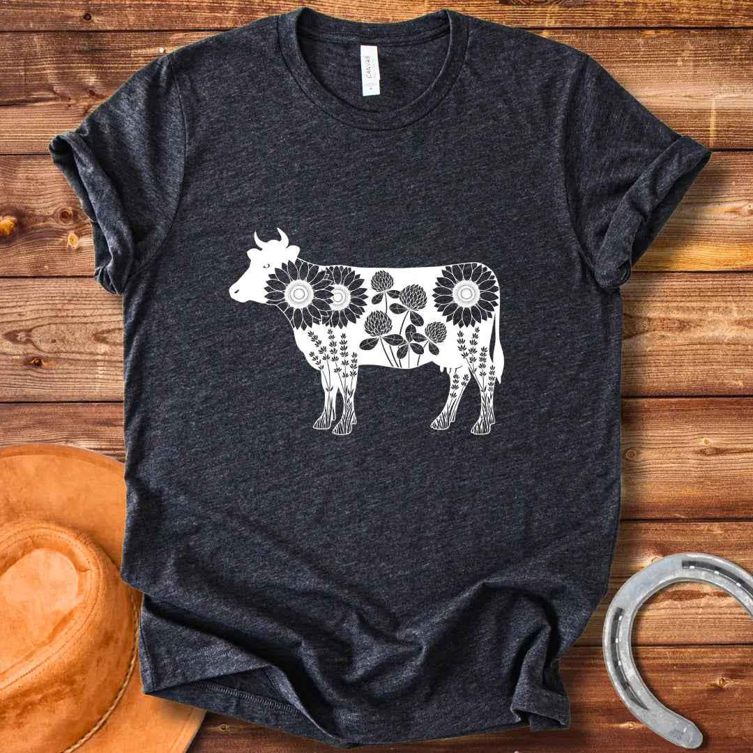Black and white illustration of a cow filled with sunflowers, clover and lavender flowers