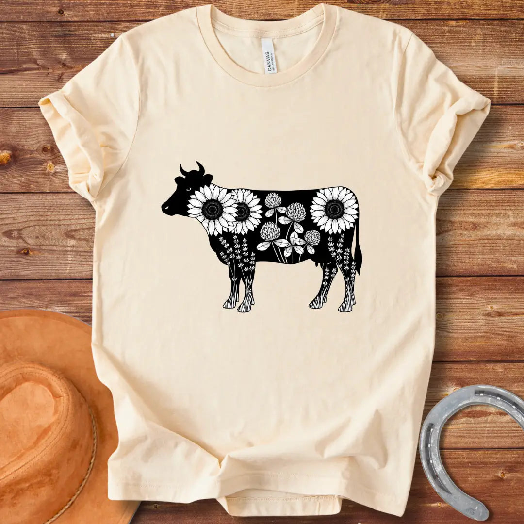 Black and white illustration of a cow filled with sunflowers, clover and lavender flowers