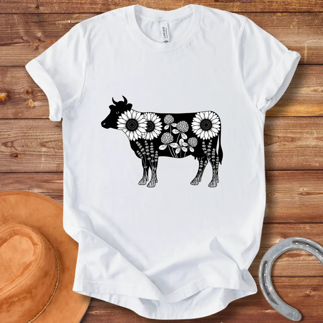 Black and white illustration of a cow filled with sunflowers, clover and lavender flowers
